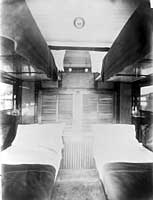 Interior sleeping compartment - second class set up for night, circa 1917.