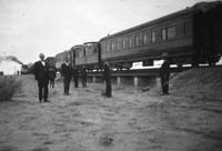 'a_a0206 - 3.1925 - Central Australia Railway Train on Coward Springs Bridge - the sleeping car is most likely SAR car <em>Nilpena</em>'