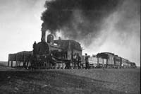 'a_a0209 - 5.1925 - Central Australia Railway NFB class loco on Ghan - William Creek - the sleeping car is most likely SAR car <em>Nilpena</em>'