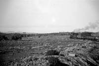 'a_h041 - Circa 1930 - Central Australia Railway, North approach to Beltana - train in left of picture '