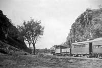 'a_h048 - Circa 1930 - Central Australia Railway <em>Ghan</em>, Heavitree Gap Alice Springs. The car behind the locomotive is the "NRP 24"'