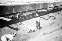 'a_h067 - circa 1930s - Central Australia Railway using sand scoops in cutting and NTB 352 water wagon '
