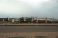 'cd_p0111984 - 17<sup>th</sup> December 1997 - Spencer Junction - 508 + open wagons - derelict carriages in background'