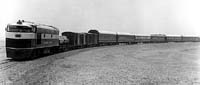 'cr57 - 1970s - NT 66 at the head of a made up Ghan consist taken just outside Marree for publicity purposes. Some of the cars are possbily on standard gauge as the NT is standing on dual gauge track'