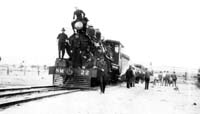 'mbc_04 - 1929 - The first C.R. train to enter Alice Springs (Stuart) NM 22. This was a stock train and arrived before the first Ghan to Alice Springs. W.J.Crowe on headlight (fireman), Jack McPherson (driver) on toolbox. Stock was from "Bonnings" and involved 2 trains.  Also Lionel Kingston (Punch), Fred Swanson, Guards Dick Johnson and Bert Garlic.  (W.J.Crowe Collection)'