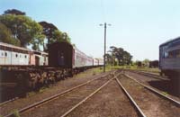 'pda_6085_23 - Saturday 21<sup>st</sup> October 2000 - Two <em>Overland</em> sleepers, A Former Victorian Railways BRS Snack Bar/Economy 48 seat compartment type sitting car: BRS 225 and another <em>Overland</em> sleeper, all now owned by West Coast Railway are shown here stored awaiting possible future restoration in the companies Ballarat East Workshops. <p>BRS 225 was later outshopped from the West Coast Railway Ballarat East Workshops in September 2001 after having undergone a major overhaul as part of a major upgrade of the West Coast Railway Carriage Fleet. This included: Repainting the exterior paint scheme from the <em>V/LINE</em> Tangerine orange and grey paint scheme to the West Coast Railway blue, white & grey Livery. (BRS 225 was last given a repaint in the <em>V/LINE</em> Tangerine & Grey Livery in 1992). This major overhaul also involved replacing the original <em>V/LINE</em> brown/orange cloth seat upholstery with the West Coast Railway blue/grey cloth seat upholstery, fitting of new West Coast Railway Blue/White curtains and the laying of new grey carpet & installing a new retention toilet in the place of the original drop-chute toilet.'