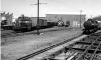 'sg48 - 1976 - A DE class locomotive and an MDH locmotive (at rear) at Port Augusta Workshop. (photo: John Gordon)'