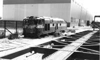 'sg52 - 1976 - Unidentified NT class locomotive (either NT 70 or 75) at Port Augusta Workshops shows the damage caused by the accident at Darwin on 4.11.1972. (photo: John Gordon)'