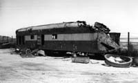 'sg53 - 1976 - Unidentified NT class locomotive (either NT 70 or 75) at Port Augusta Workshops shows the damage caused by the accident at Darwin on 4.11.1972. (photo: John Gordon)'